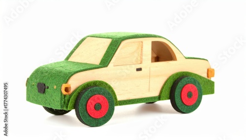 A wooden toy car with green and beige parts sits on a .