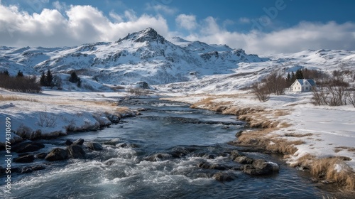 A serene winter landscape with a flowing river, snow-covered mountains, and a small house nestled among the trees.