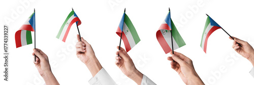 The Equatorial Guinea flag in hand in different angles on a white background