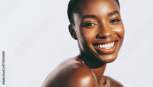 Close up of a smiling African woman's face with smooth glowing skin Happy