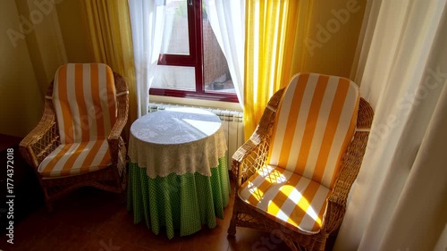 Cozy Wicker Chairs With Yellow Striped Cushions By Sunlit Window. Time lapse