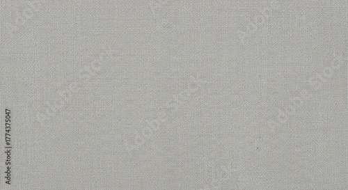 A close-up, high-angle shot of a plain, light gray textured fabric surface.