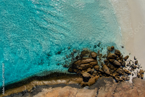Crystal clear waters ripple in the wind as they gently wash over the rocks