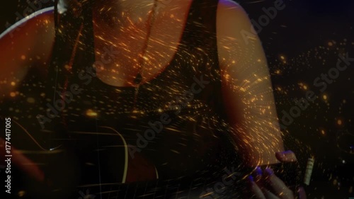 Female music artist strumming guitar, emitting golden particles swirling singing into microphone