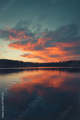 Wallpaper Mural Evening landscape photography of lake surface reflecting burning sunset clouds. Noise texture and soft fade at edges emphasize retro cinematic tone, evoking calm melancholy and poetic Torontodigital.ca
