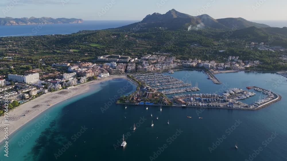Aerial Sunrise Over Alcúdia Bay: Water front Resorts and Hotels over look the Beach, and Port in Mallorca, Spain