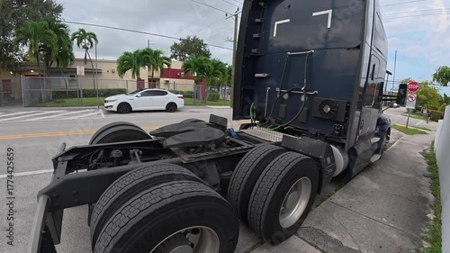 Empty semi-truck parked on a quiet urban street