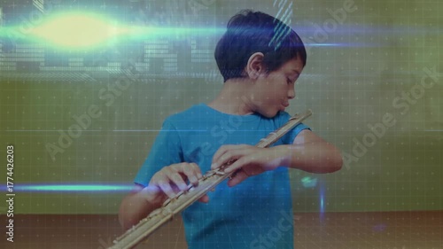 Boy lifting flute to lips and fingering notes in music practice while glitch overlays intensifying