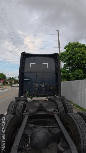 Empty semi-truck parked on a quiet urban street