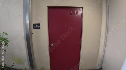 Red door to classroom 101 in a school 