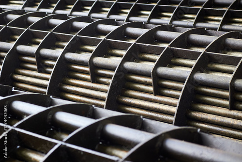 Shell and Tube Heat Exchangers tube bundle baffle details of industrial heat exchanger shell and tube condenser made of steel. Abstract industrial background of steel heat exchanger tube bundles.