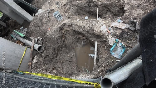 An excavated trench for plumbing or electrical lines at an early stage construction site
