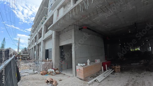 Construction site with large utility pipes and building on support pillars