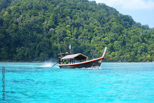 Beautiful view of local wooden boat used to transport tourists across the sea and tropical beach on Surin islands in National Park, Phang Nga of Thailand