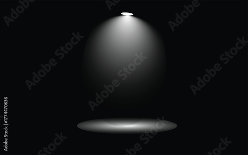 Spotlight shining down in the darkness illuminating a small area below