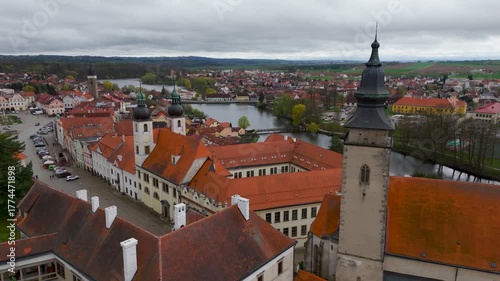 Wallpaper Mural Aerial drone close-up shot circling the historic Gothic church tower in the UNESCO World Heritage town of Telč, Vysocina, Czech Republic. Torontodigital.ca