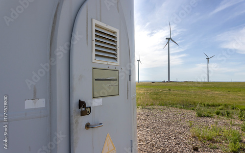 metal entrance door to a wind turbine with signs
