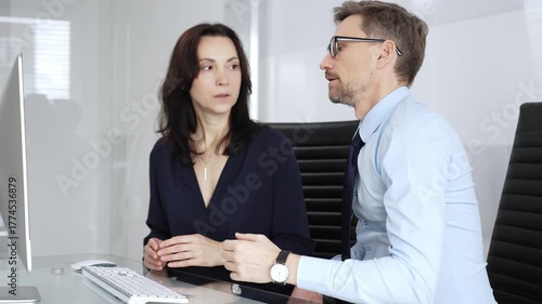 Wallpaper Mural Business professionals collaborating at a desk, reviewing data and strategy on a computer, mentoring and problem solving together to drive results in a modern office setting Torontodigital.ca