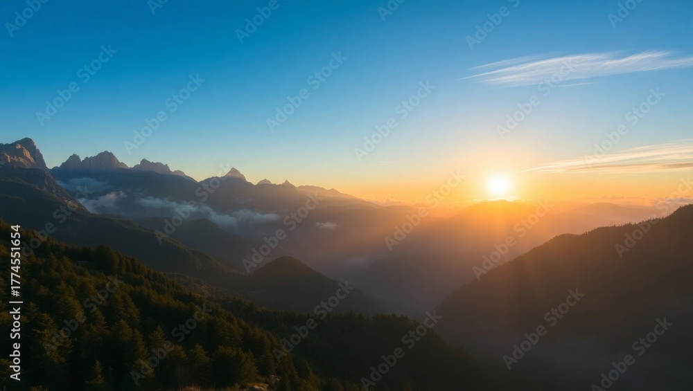 Obraz premium Dramatic mountain sunset with golden light and vibrant blue sky scenery