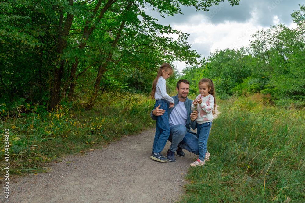 Fototapeta premium Father and children have fun, laugh and enjoy nature outdoors.