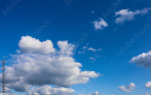 Beautiful blue sky with fluffy white clouds, perfect for background, wallpaper, or design projects.