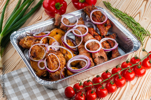 Grilled meat set, shashlik on a wooden table
