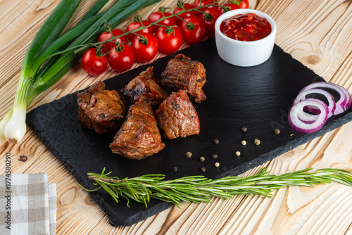 Grilled pork neck, shashlik on a wooden table