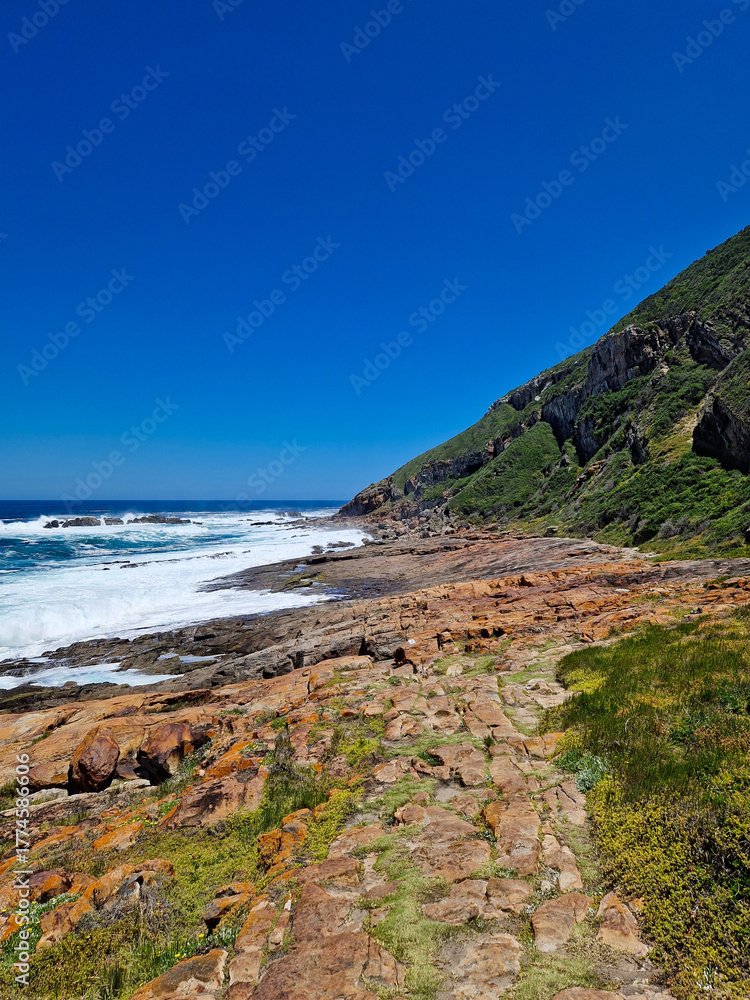 Fototapeta premium Scenic view of the rocky coastline at Robberg Nature Reserve, South Africa.