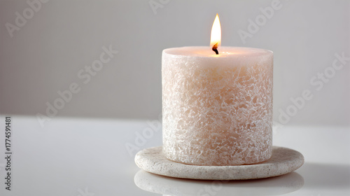 Wallpaper Mural White textured candle glows with soft light on stone coaster. Suitable for lifestyle imagery, branding, or poster design. Torontodigital.ca