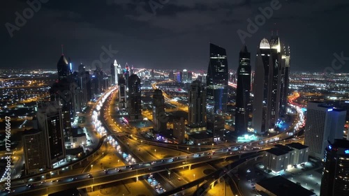 Illuminated skyscrapers and highway light trails aerial night view of Riyadh city center