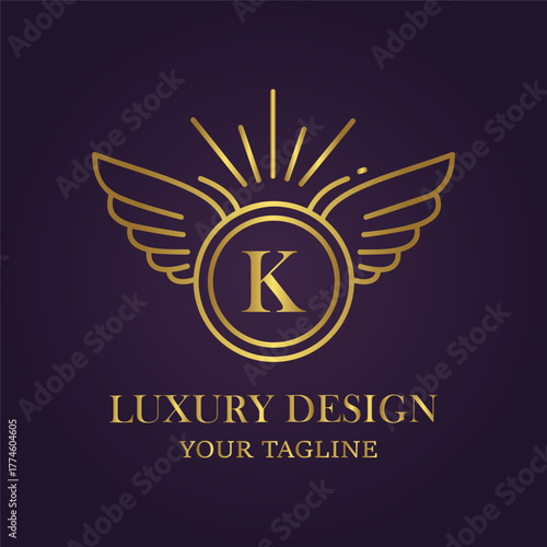 Elegant golden winged emblem with letter k inside a circle, set against a dark purple background, symbolizing luxury and design