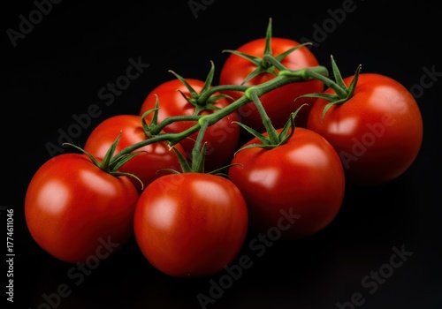 Bright red vine ripened tomatoes clustered together still attached to the green stem perfect for healthy cooking ingredients ,cooking ,farming ,gardening