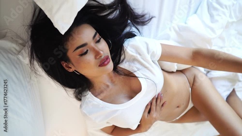 Sexy Asian Woman Posing For Selfie Smartphone Camera, Lying in Bed in White Lingerie, Slow Motion