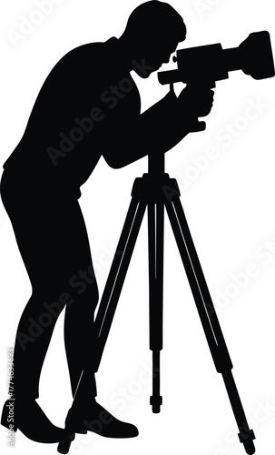 Silhouette of a cameraman operating a video camera on a tripod