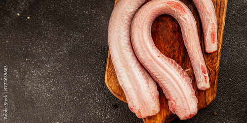 Raw rock eel fish rock salmon shark seafood small-spotted catshark tasty snack fresh delicious gourmet food background on the table rustic top view copy space pescetarian diet