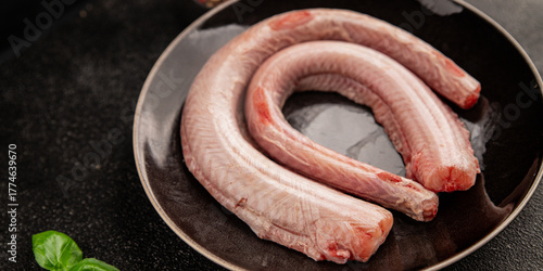 Raw rock eel fish rock salmon shark seafood small-spotted catshark tasty snack fresh delicious gourmet food background on the table rustic top view copy space pescetarian diet