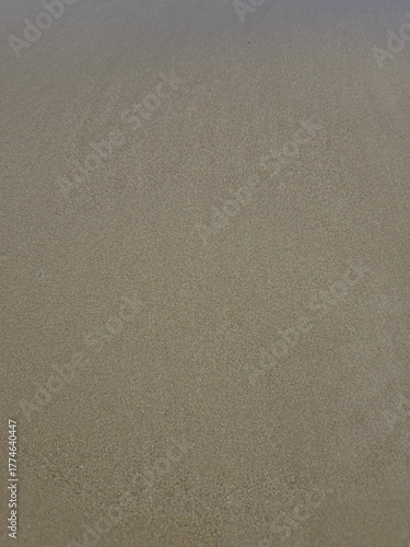 texture of sand. 
Wet sand on a deserted beach after a storm