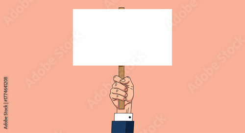 A hand in a business suit holds a blank white protest sign on a wooden stick, ready for a personalized message, against a plain peach background.