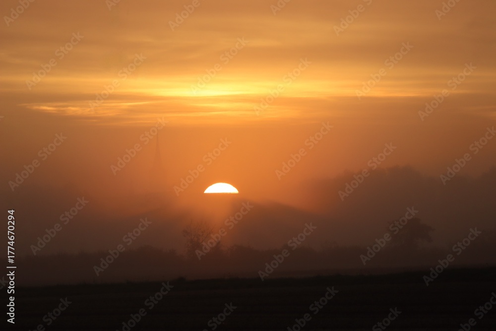 Fototapeta premium Church tower in the half-Sun