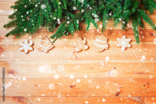Christmas border with gingerbread cookies on wooden background