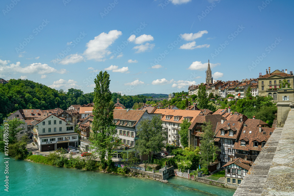 Obraz premium View of the city of Bern in Switzerland Part of the Aare River and the bridge are visible The weather is sunny and clear, the sky is blue with a few clouds