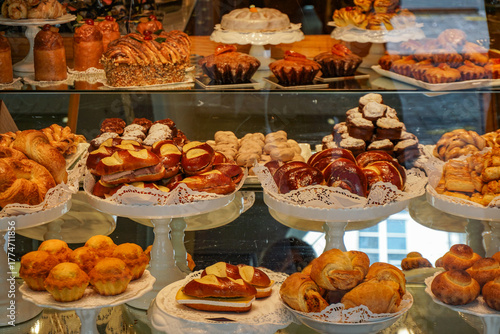 A bakery display case with a variety of pastries and cakes