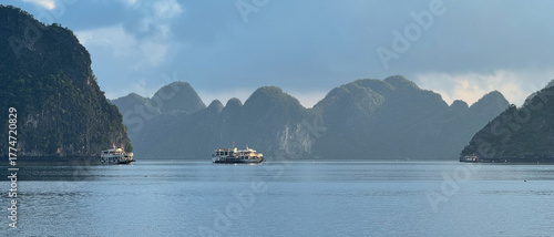 Boats navigating Ha Long Bay Vietnam limestone karsts