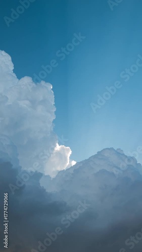 Vertical video - Timelapse of sun rays passing through thick clouds in the afternoon