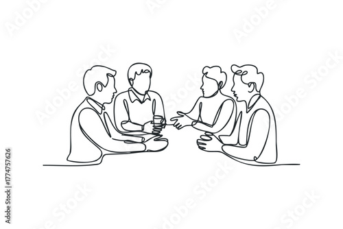 Four People Sit Around Table Discussing Ideas