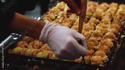 Takoyaki - popular Japanese Street Food, deep-fried dough octopus dumpling balls, variety of different traditional food snack selection in Osaka, Japan, street market with local vendor stalls cooking
