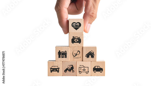 Hand building a pyramid of wooden blocks with health, life, and property insurance icons