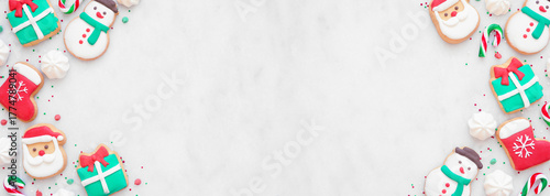Colorful Christmas sweets double border on a white marble banner background with copy space. Top down view. Holiday baking concept.