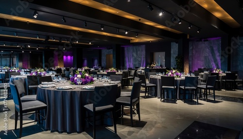Elegant Venue with Prepared Tables: Capture the sophistication of a venue with round tables, draped in elegant cloths, ready for a special event. The low lighting casts shadows.