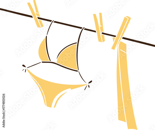 mustard yellow bikini hanging on clothesline 